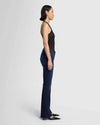 Side view of 7 for All Mankind Bootcut Tailorless Jeans in inky blue wash, highlighting the fitted hips and thigh with a classic bootcut flare, available at Lemonberry in Aurora, ON.