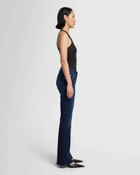 Side view of 7 for All Mankind Bootcut Tailorless Jeans in inky blue wash, highlighting the fitted hips and thigh with a classic bootcut flare, available at Lemonberry in Aurora, ON.