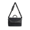 Side view of the pixie mood vegan weekender handbag with shoulder strap extended.