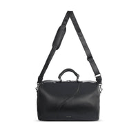 Side view of the pixie mood vegan weekender handbag with shoulder strap extended.