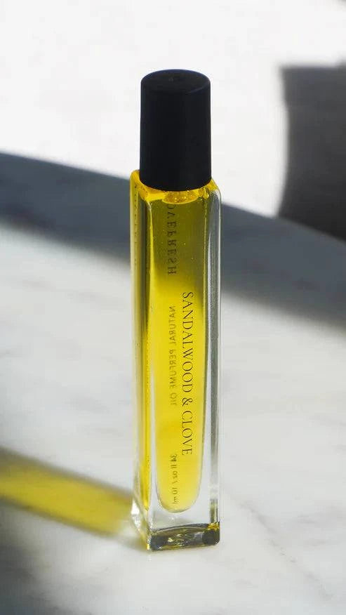  Close-up of Sandalwood and Clove Natural Perfume Oil with a warm, earthy fragrance.