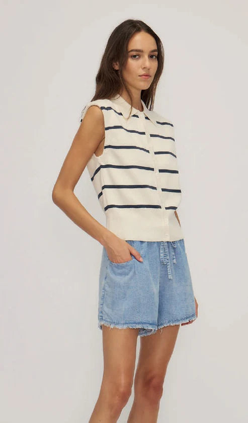 Adella Top by Melissa Nepton in navy stripes, worn with blue shorts. Sleeveless knit vest with button-down design, classic collar.