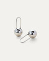 Celeste Earrings in silver displayed on a white background, highlighting their modern drop design.