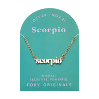 Foxy Originals Scorpio Zodiac Necklace on its display card, featuring a gold script-style pendant with stylish packaging.