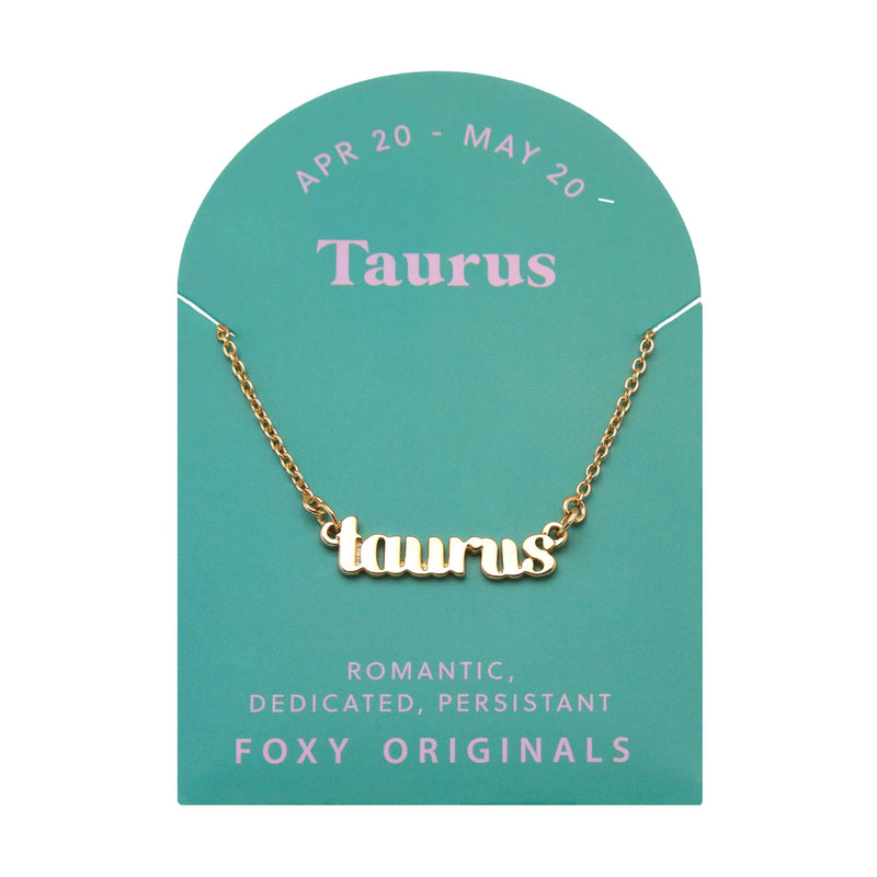 Foxy Originals Taurus Zodiac Necklace on its display card, featuring a gold script-style pendant with stylish packaging.