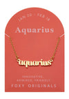 Foxy Originals Aquarius Zodiac Necklace on its display card, featuring a gold script-style pendant and elegant packaging.