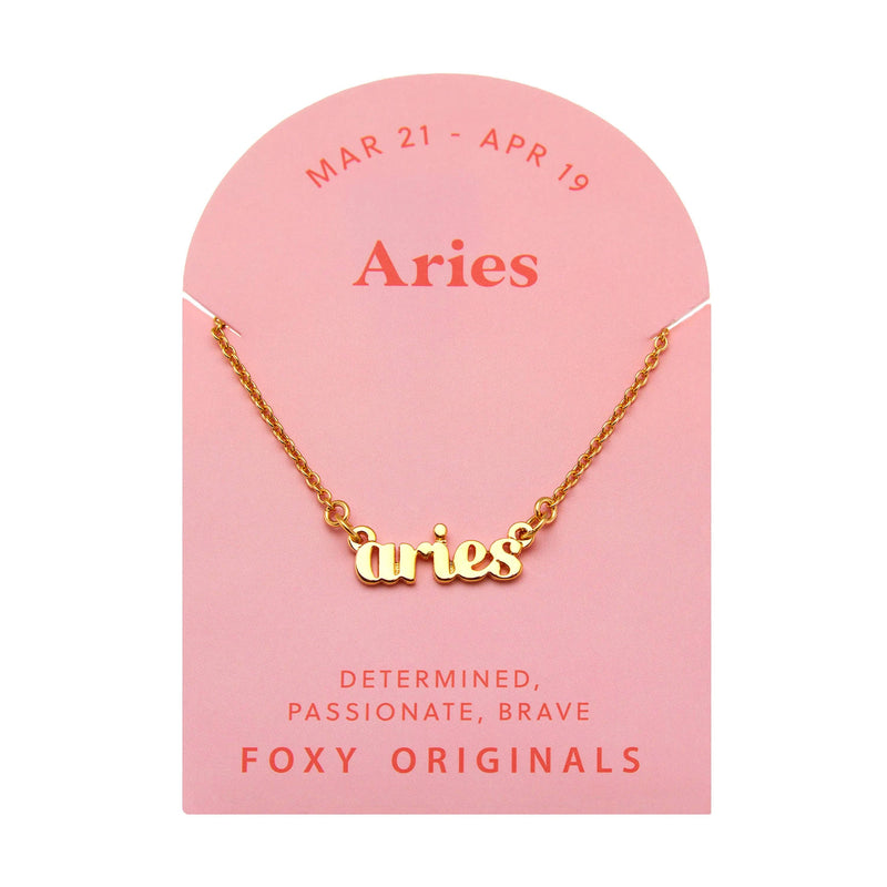 Foxy Originals Aries Zodiac Necklace on its display card, showcasing a gold script-style pendant with elegant packaging.