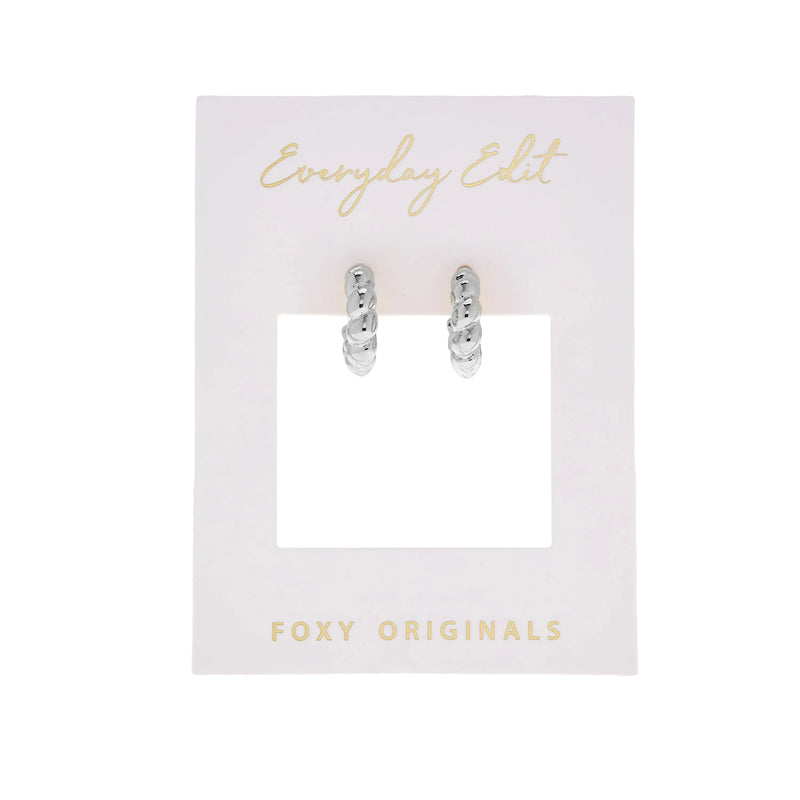 The Croissant Earrings in Silver by Foxy Originals, photographed against a white display card. Canadian-made, woman-owned, and a stylish everyday staple.