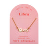 Foxy Originals Libra Zodiac Necklace on its display card, featuring a gold script-style pendant with stylish packaging.