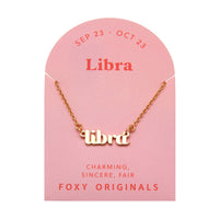 Foxy Originals Libra Zodiac Necklace on its display card, featuring a gold script-style pendant with stylish packaging.