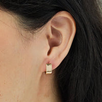 A model showcasing the Parker Earrings in Gold by Foxy Originals, handmade in Canada. Lightweight, modern, and perfect for any occasion.
