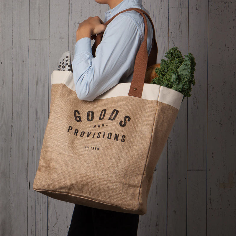 Person carrying the Goods & Provisions Market Tote by Now Designs, showcasing its eco-friendly and durable design.