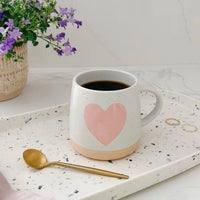 Heart-shaped mug elegantly placed on a serving tray, perfect for a cozy breakfast or tea time.