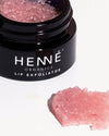 Nordic Berries Lip Exfoliator opened, showing its vivid berry color and rich, exfoliating formula.