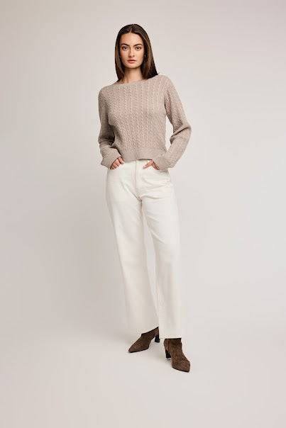 Model wearing the Janice Long Sleeve Top by Gentle Fawn, front view, neutral colour, styled with white pants.