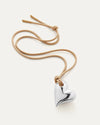 The Art Heart on a String Necklace by Jenny Bird in silver, featuring a heart-shaped pendant made from silver-tone glass, hanging from an adjustable sand-colored cord made from recycled polyester.