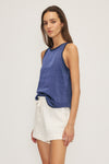 Close-up of the Kelsi Satin Mixed Media Sleeveless Top in blue, highlighting crochet neckline.