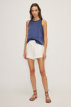 Woman wearing Kelsi Satin Mixed Media Sleeveless Top in blue, showing front details.