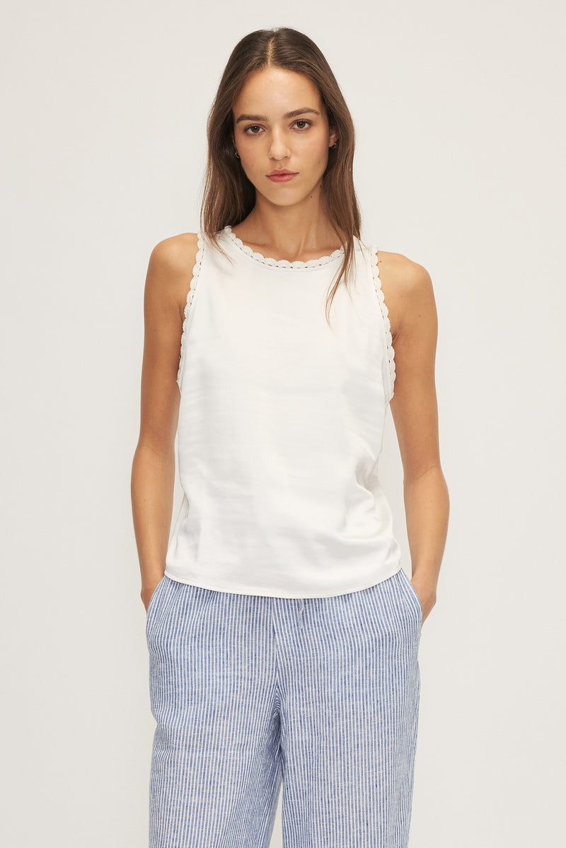 Close-up of the Kelsi Satin Mixed Media Sleeveless Top in white, showcasing crochet neckline.