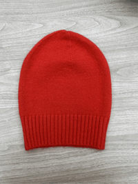 Red Lyla & Luxe Beanie on white background, featuring a snug ribbed fit perfect for winter.