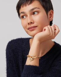 Jenny Bird Padlock Heart Chain Bracelet in gold, worn on a model’s wrist, showcasing its elegant heart-shaped padlock charm and chic chain design.