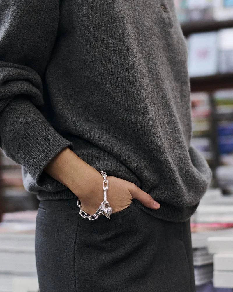 Model wearing the Jenny Bird Padlock Heart Chain Bracelet in silver, showcasing its elegant and modern design.