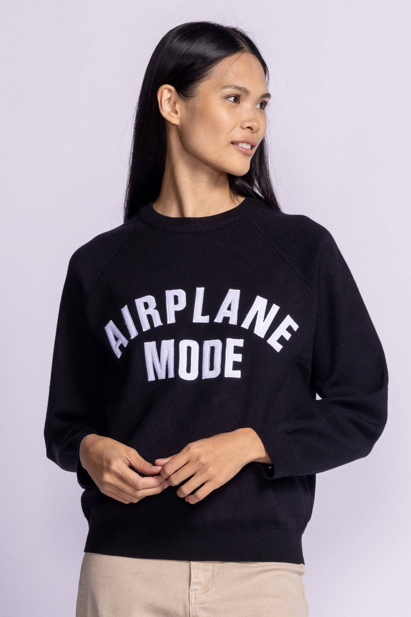 Pink Martini Catching Flights Sweater shown from the front, model turning head to the side to showcase fit and neckline.