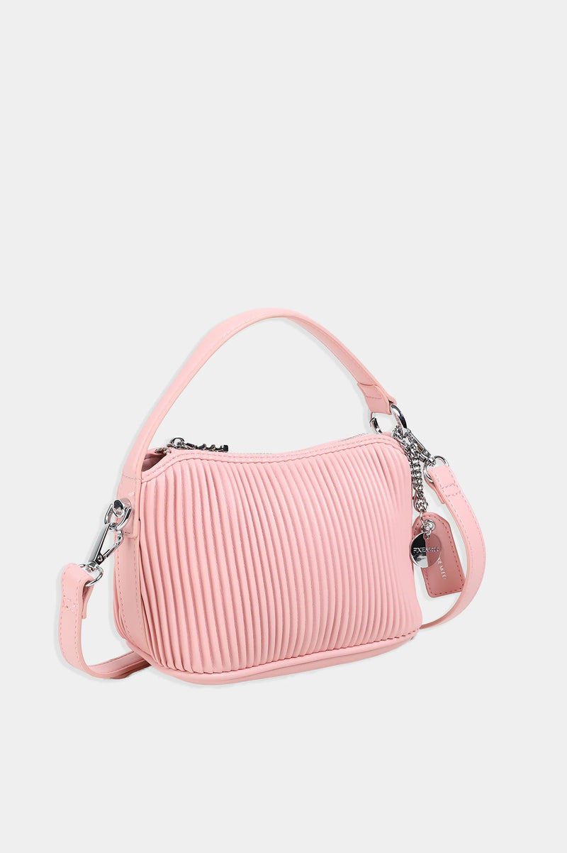 Ella Crossbody in pink by Pixie Mood, front angle view showcasing pleated design and compact shape from a slight angle.