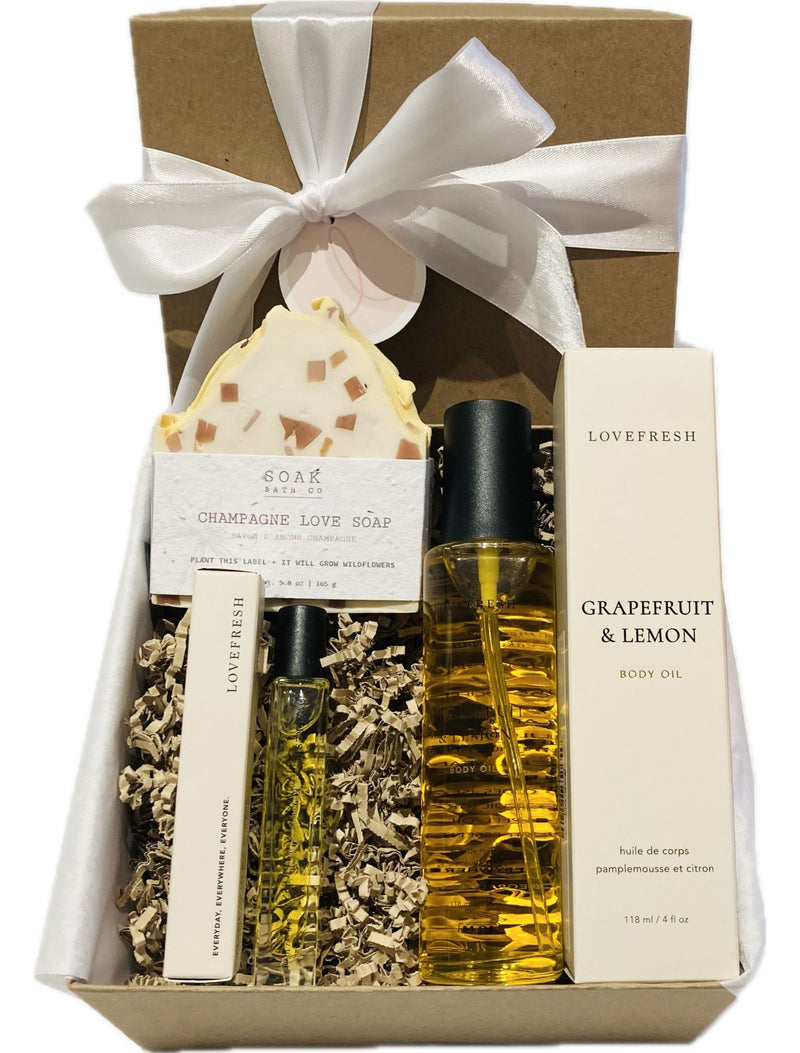 Self Love Kit featuring Lovefresh natural perfume, Lovefresh body oil, and SOAK Bath & Co champagne soap, beautifully packaged in a gift box from Lemonberry.