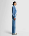 Side view of the ultra high-rise wide-leg denim in medium blue wash, showing the fitted hips and thighs, by 7 For All Mankind.