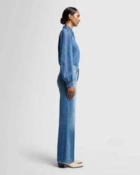 Side view of the ultra high-rise wide-leg denim in medium blue wash, showing the fitted hips and thighs, by 7 For All Mankind.