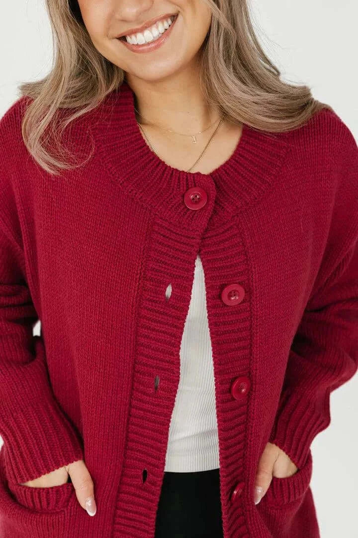 Close-up front view of the Smash + Tess Big Heart Cardigan in red, showcasing its soft knit texture, button details, and front pockets. Available at Lemonberry, Aurora, ON