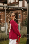 Side view of the Smash + Tess Big Heart Cardigan in red, showcasing its relaxed fit, soft knit texture, and large pink heart detail. Available at Lemonberry, Aurora, ON.