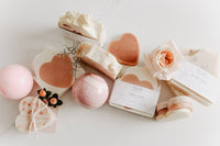 A variety of handmade vegan soaps by SOAK Bath Co, a Canadian, woman-owned brand, featuring eco-friendly, plant-based ingredients and biodegradable seed paper packaging.
