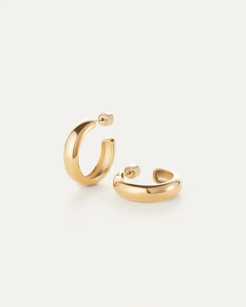 Staple Hoops Medium Earrings in gold resting on white table by Jenny Bird