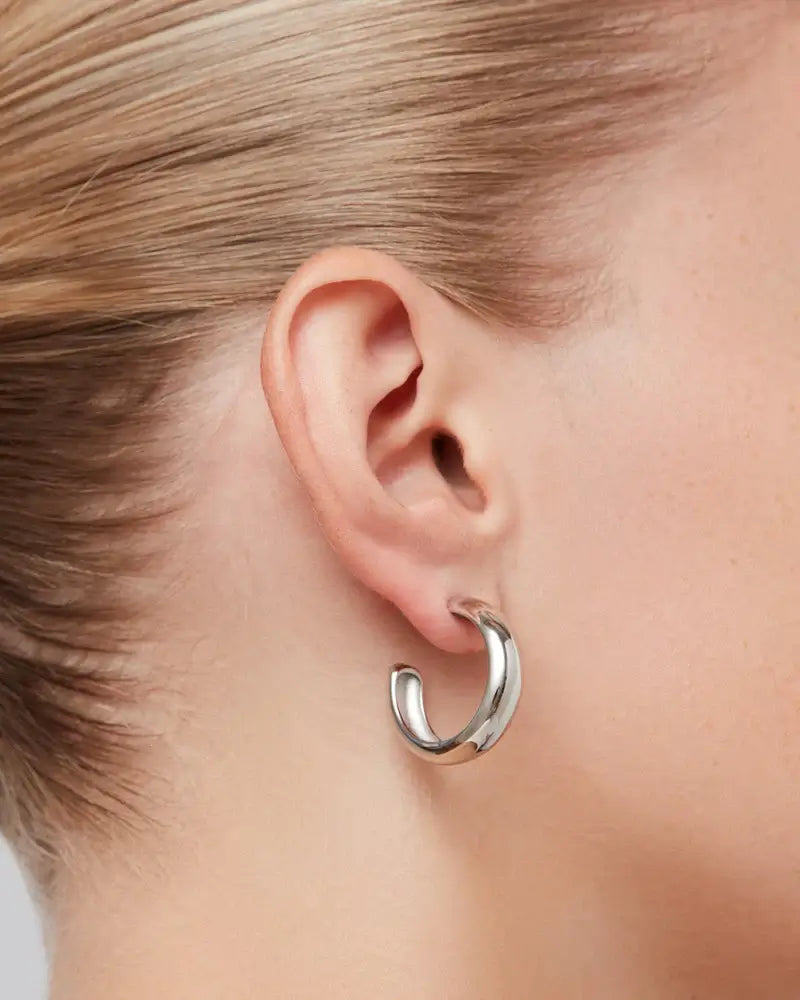 Staple Hoops Medium Earrings in silver worn on ear by Jenny Bird