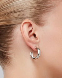 Staple Hoops Medium Earrings in silver worn on ear by Jenny Bird