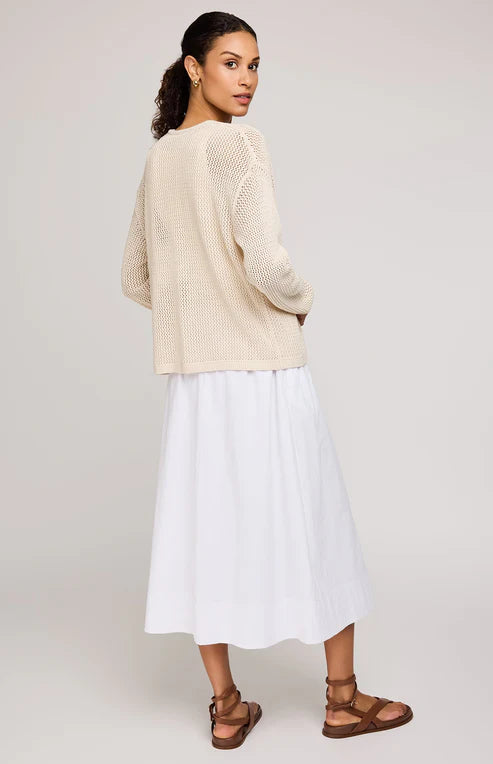 Back view of model wearing Gentle Fawn Toledo open knit cardigan over a white dress, emphasizing the relaxed design and casual silhouette.