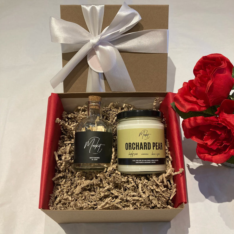 Open Valentine’s Gift Box from Lemonberry featuring a Market Candle Company candle, wood matches, and beautifully wrapped packaging with ribbon and tissue.