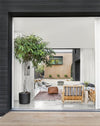 A beautifully framed view from an interior space into a serene outdoor room, showcasing seamless indoor-outdoor living from "Made for Living."