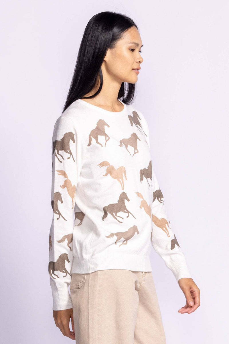 Model wearing the Wild Horses Sweater from a side angle, highlighting its unique equestrian-inspired design.