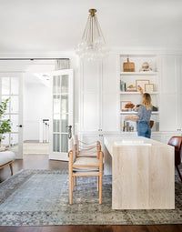 A thoughtfully designed work area featuring warm wood tones, layered textures, and natural light, as seen in "Made for Living."