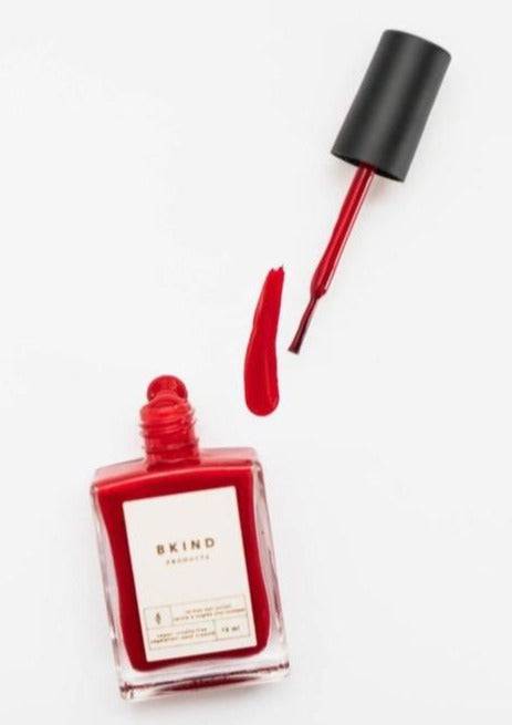 Bkind Nail Polish in a vibrant red bottle, offering a bold and long-lasting manicure.