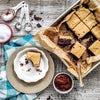 Dessert squares from the "Delicious and Doable" cookbook by Charmaine Broughton, showcasing a sweet, indulgent treat perfect for satisfying your cravings.