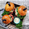 Three delicious sloppy lamb burgers from the "Delicious and Doable" cookbook by Charmaine Broughton, served on a plate, ready to enjoy.