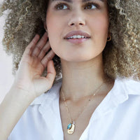 Model wearing a Foxy Originals Birthstone Necklace, featuring a gold-plated charm with a colorful birthstone accent, elegantly layered for a timeless look.