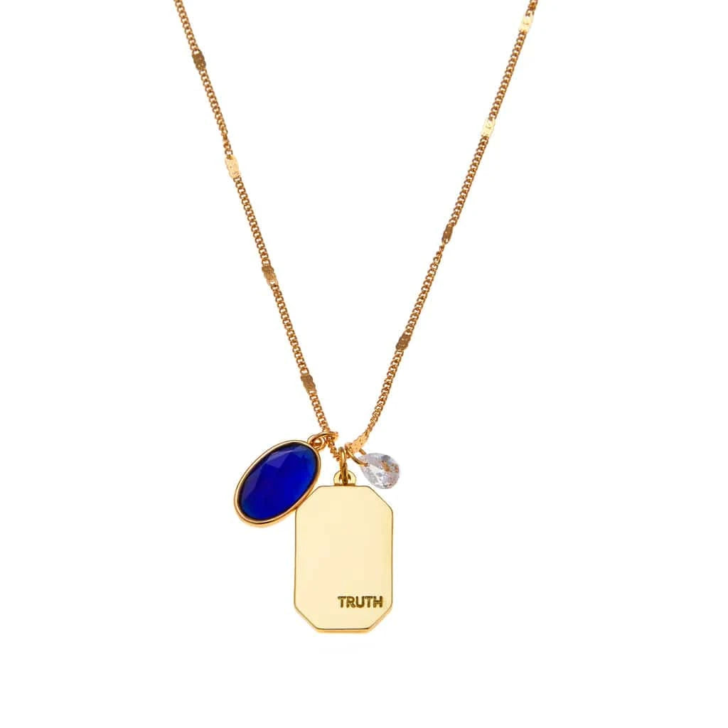 Close-up of Foxy Originals Sapphire Birthstone Necklace, showcasing the gold-plated charm with a sapphire-toned stone, representing truth.