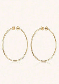 Jenny Bird Icon Hoops in high-polish gold, featuring a sleek 360-degree full-circle design.