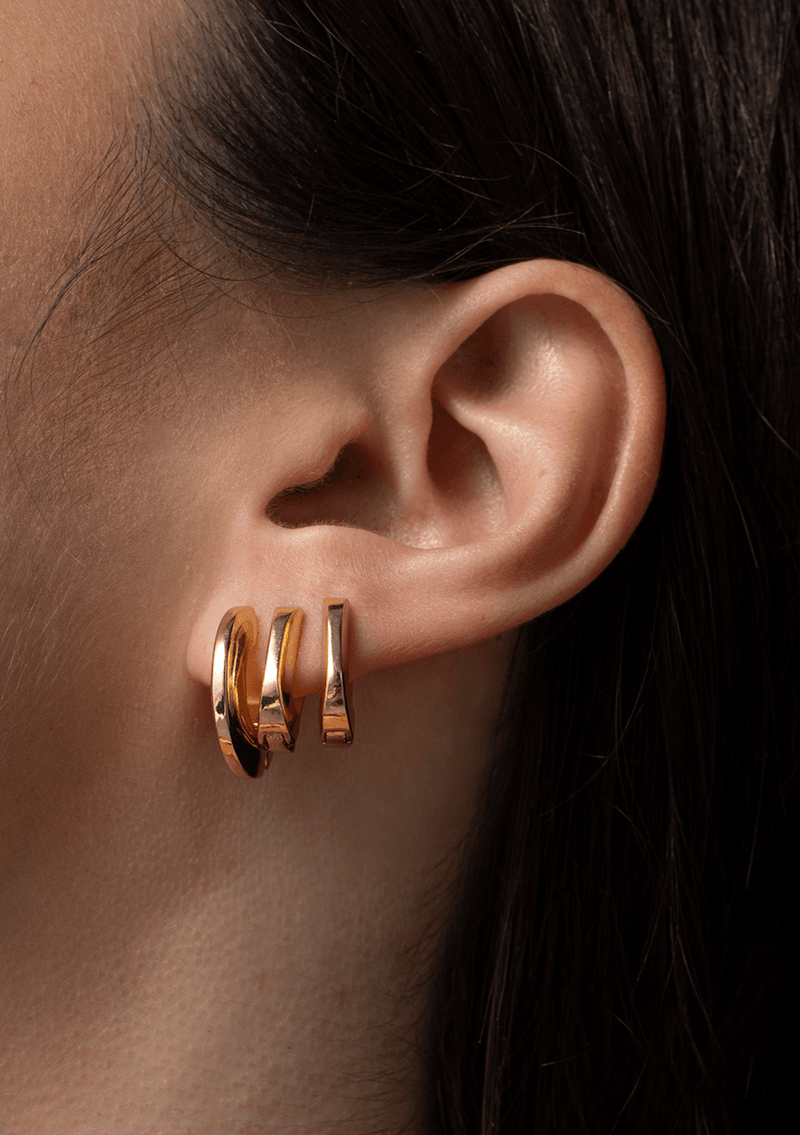 Teeni Tony by Jenny Bird gold huggie earrings worn by a different model, highlighting their elegant and minimalistic design.
