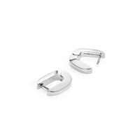 Teeni Tony by Jenny Bird silver huggie earrings on a white background, highlighting the sleek, high-polish finish.